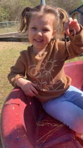 Prek child holding worm