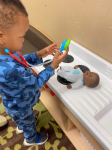 PreK child taking the heartbeat of a doll