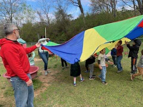 children playing with parachute